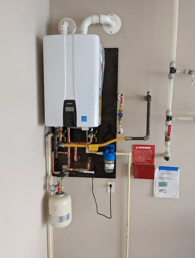 Professional plumber installing copper piping in a South Portland home